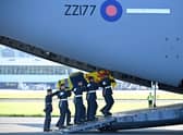 Pallbearers from the Queen's Colour Squadron of the Royal Air Force (RAF) carry the coffin of Queen Elizabeth II, draped in the Royal Standard of Scotland, into a RAF C17 aircraft at Edinburgh Airport.