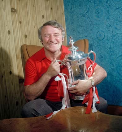 Tommy Docherty with the FA Cup after Manchester United's win in 1977