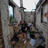 Volunteers clear the rubble of a house destroyed as a result of the shelling in the city of Chernihiv. - Russia's withdrawal from Chernihiv in April, after a month-long assault left behind a devastated city that Ukraine will needs massive foreign aid, and many years of work, to restore.