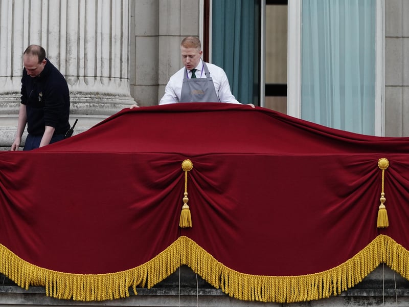 Final preparations on the balcony of Buckingham Palace, London, ahead of the Coronation of King Charles III and Queen Camilla today