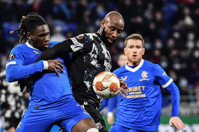 Rangers defender Calvin Bassey challenges Lyon forward Moussa Dembele (Photo by JEFF PACHOUD/AFP via Getty Images)