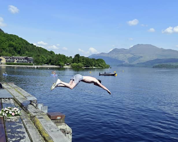 A swimmer at Loch Lomond. Scots in some parts of the country can expect temperatures around 24C to 26C - possibly even 27C in the north-east of the country on Monday. Picture: John Devlin