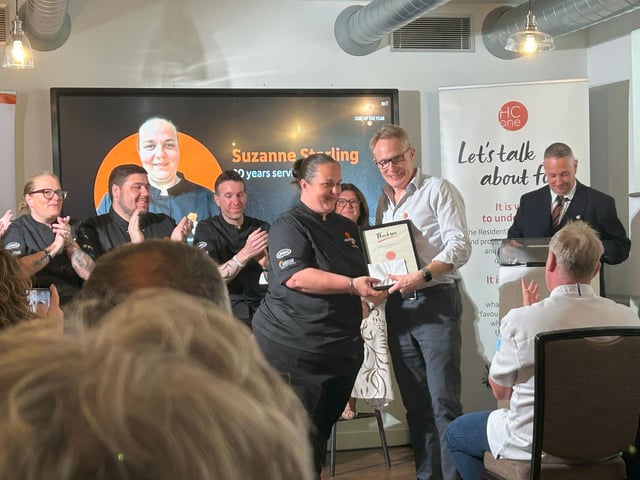 Suzanne Stirling, Group Development Chef at HC-One being presented with her 20 year long service award by James Tugendhat, Chief Executive Officer at HC-One at the HC-One Chef of the Year Competition 2025