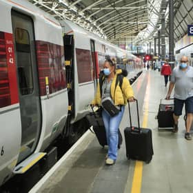 Passengers wearing face masks boarding a LNER train. Picture: Danny Lawson.
