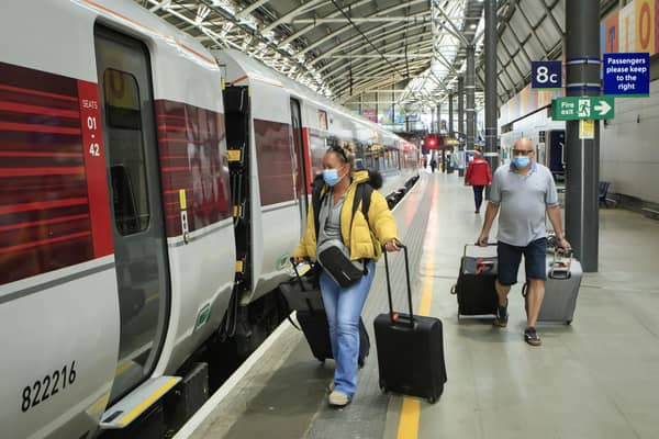Passengers wearing face masks boarding a LNER train. Picture: Danny Lawson.