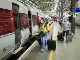 Passengers wearing face masks boarding a LNER train. Picture: Danny Lawson.
