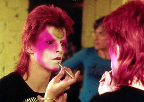 David Bowie applying his Ziggy Stardust makeup in the 1970s. Picture: R Bamber/Rex Features