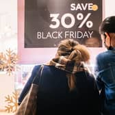 Shoppers view merchandise through a store window during Black Friday sales. Picture: Brandon Bell/Getty Images