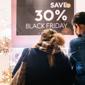 Shoppers view merchandise through a store window during Black Friday sales. Picture: Brandon Bell/Getty Images
