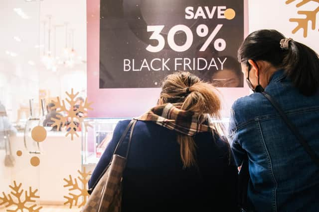 Shoppers view merchandise through a store window during Black Friday sales. Picture: Brandon Bell/Getty Images