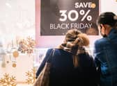 Shoppers view merchandise through a store window during Black Friday sales. Picture: Brandon Bell/Getty Images