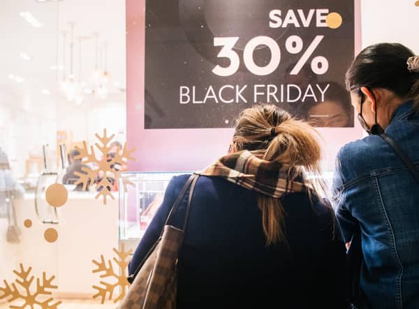 Shoppers view merchandise through a store window during Black Friday sales. Picture: Brandon Bell/Getty Images
