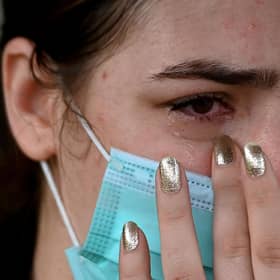 An Afghan woman living in India reacts outside the embassy of the United States of America in New Delhi (Photo by Money Sharma / AFP) (Photo by MONEY SHARMA/AFP via Getty Images)