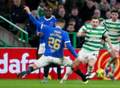 Celtic's James Forrest (R) goes past Rangers' Leon Balogun.