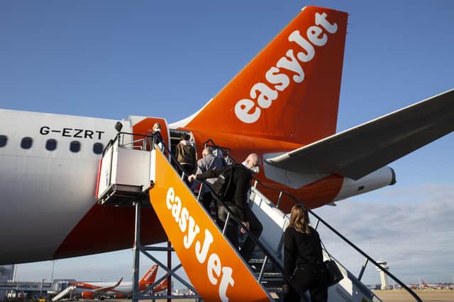 Passengers board easyJet flight EZY883 before it takes-off from London Gatwick bound for Glasgow