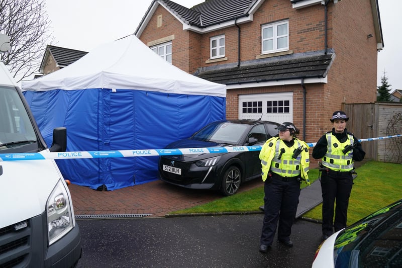 Officers from Police Scotland stand beside by police tape and a police tent outside the home of former chief executive of the SNP Peter Murrell, in Uddingston, Glasgow, after he was arrested in connection with the ongoing investigation into the funding and finances of the party.