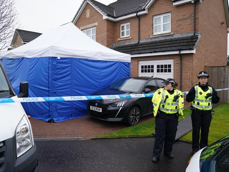 Officers from Police Scotland stand beside by police tape and a police tent outside the home of former chief executive of the SNP Peter Murrell, in Uddingston, Glasgow, after he was arrested in connection with the ongoing investigation into the funding and finances of the party.