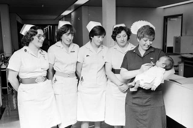 Nurses at Kings Mill Hospital in 1980 holding a new arrival