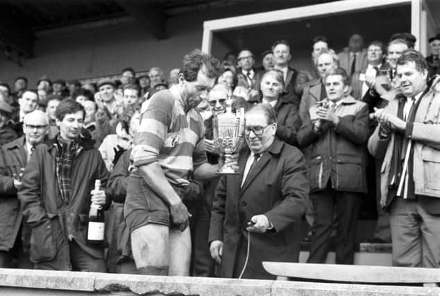 Gary Callander is presented with the McEwan's Division One trophy after Kelso clinched the Scottish championship in March 1988.