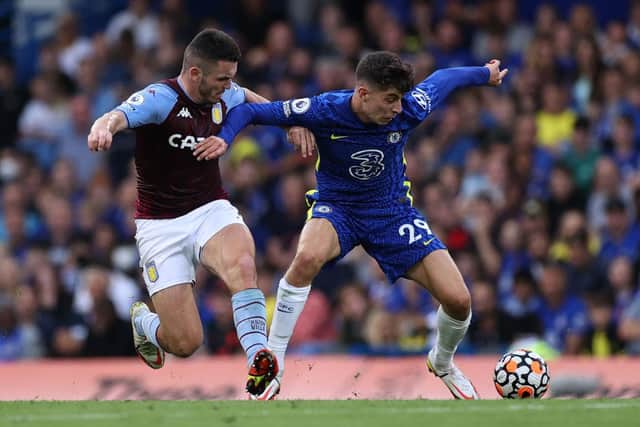 Kai Havertz of Chelsea is challenged by John McGinn of Aston Villa. (Photo by Eddie Keogh/Getty Images)