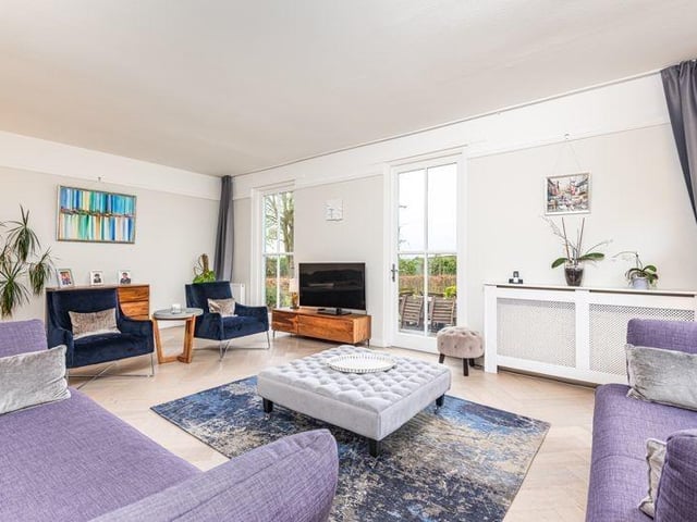 The formal lounge benefits from south facing windows, double doors leading into the front garden, and a fully glassed side wall.