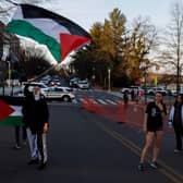 People participate in a vigil for US Air Force airman Aaron Bushnell outside the Israeli Embassy. Mr Bushnell died after setting himself on fire while live streaming in front of the Israeli Embassy in protest over the Gaza war. (Photo by Anna Moneymaker/Getty Images)