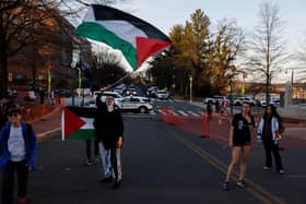 People participate in a vigil for US Air Force airman Aaron Bushnell outside the Israeli Embassy. Mr Bushnell died after setting himself on fire while live streaming in front of the Israeli Embassy in protest over the Gaza war. (Photo by Anna Moneymaker/Getty Images)