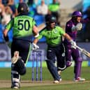 Ireland's Curtis Campher and George Dockrell run between the wickets as Scotland's wicketkeeper Matthew Cross shouts for fielding during the T20 World Cup match in Hobart.  (Photo by DAVID GRAY/AFP via Getty Images)
