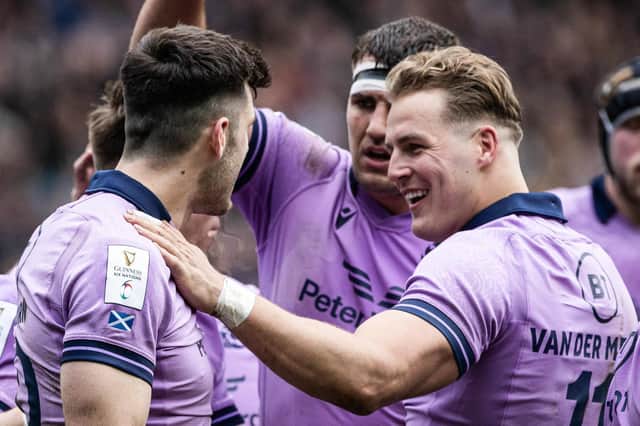 Scotland's try scorers Duhan Van Der Merwe (R) and Blair Kinghorn (L) celebrate during the win against Italy.