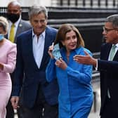 Britain's President for COP26 Alok Sharma (right) accompanies US Speaker of the House Nancy Pelosi as they walk up Downing Street in London. Picture: Ben Stansall/AFP via Getty Images