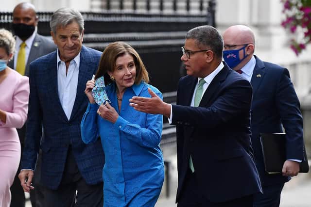 Britain's President for COP26 Alok Sharma (right) accompanies US Speaker of the House Nancy Pelosi as they walk up Downing Street in London. Picture: Ben Stansall/AFP via Getty Images