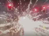 A firework explodes near traffic lights in Edinburgh's Niddrie area