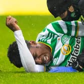 Celtic's Jeremie Frimpong writhes in agony after the challenge from Devante Cole that has led to fears of ligament damage (Photo by Craig Williamson / SNS Group)