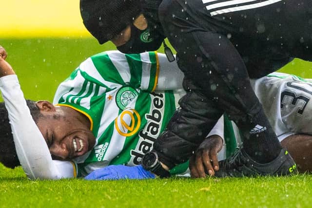 Celtic's Jeremie Frimpong writhes in agony after the challenge from Devante Cole that has led to fears of ligament damage (Photo by Craig Williamson / SNS Group)
