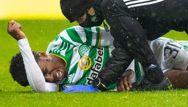 Celtic's Jeremie Frimpong writhes in agony after the challenge from Devante Cole that has led to fears of ligament damage (Photo by Craig Williamson / SNS Group)