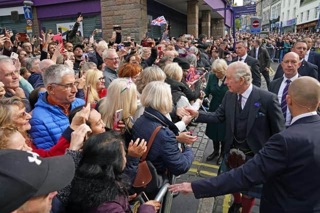 King Charles III greets members of the public as he arrives at an official council meeting at the City Chambers in Dunfermline