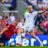 Lyndon Dykes nips ahead of Norway defender Leo Skiri Ostigard to net Scotland's equaliser. (Photo by FREDRIK VARFJELL/NTB/AFP via Getty Images)