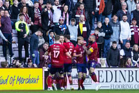Marley Watkins is mobbed by his Kilmarnock team-mates after levelling at Tynecastle.
