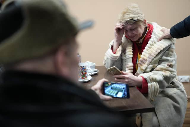 A Ukrainian woman, one of a number of refugees being carried by a convoy of Spanish taxi drivers from Poland to Spain, cries as she phones her husband during a stop at a roadside restaurant (Picture: Cesar Manso/AFP via Getty Images)