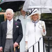King Charles III and Britain's Queen Camilla pause for the National Anthem, as they host guests for a Garden Party at the Palace of Holyroodhouse in Edinburgh. Picture: Jonathan Brady/POOL/AFP via Getty Images