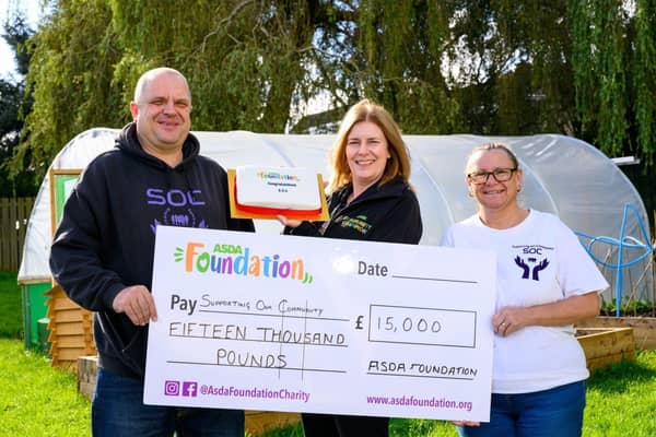 Asda Commmunity Champion Gillian Summers celebrates with Supporting Our Community.