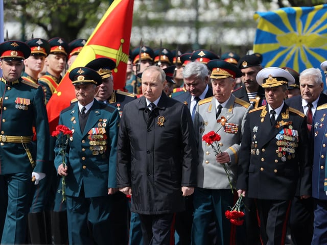 Russian President Vladimir Putin attends a flower-laying ceremony at the Tomb of the Unknown Soldier after the Victory Day military parade in central Moscow. Photo by Anton Novoderezhkin via Getty Images)