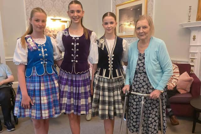 Highland dancers at HC-One Scotland’s Murrayfield House Care Home with resident