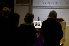 A photograph of David Amess is displayed as people wait for the start of a mass at Saint Peter's Catholic Parish of Eastwood in Leigh-on-Sea