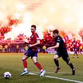 Rangers' Ryan Jack and Dundee's Owen Beck in action as flares light up the stands behind them.  (Photo by Ross Parker / SNS Group)