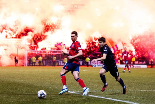 Rangers' Ryan Jack and Dundee's Owen Beck in action as flares light up the stands behind them. (Photo by Ross Parker / SNS Group)