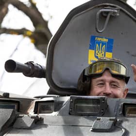 A soldier waves from an armored personnel carrier earlier this month as several villages were liberated in the Kherson district.