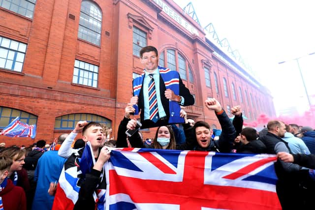 Rangers fans celebrate outside of the Ibrox Stadium after Rangers win the Scottish Premiership title. Picture date: Sunday March 7, 2021. PA Photo. See PA story SOCCER Rangers. Photo credit : Jane Barlow/PA Wire.