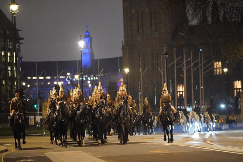 Members of the military in Westminster, central London, during a night time rehearsal for the coronation of King Charles III on May 6.