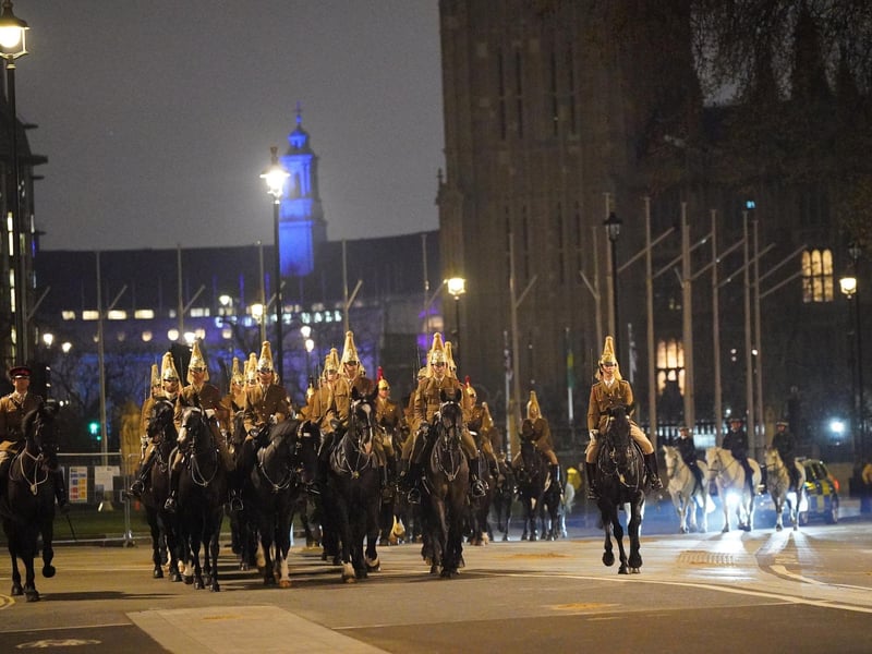Members of the military in Westminster, central London, during a night time rehearsal for the coronation of King Charles III on May 6.